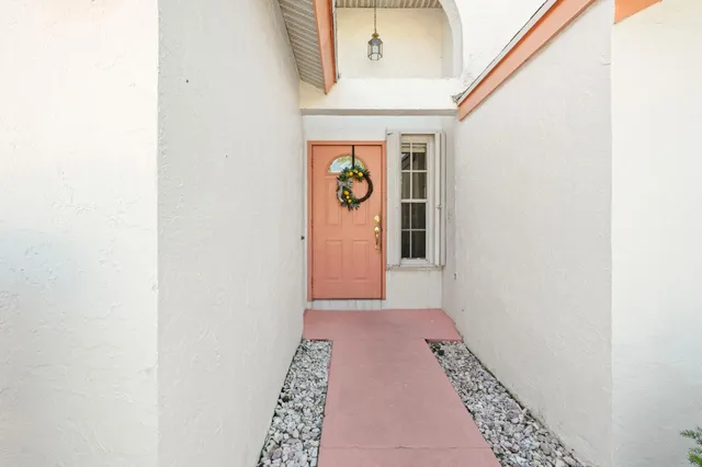 a living room with furniture a flat screen tv and a chandelier