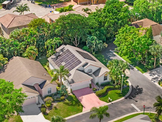 an aerial view of a house with a yard and potted plants