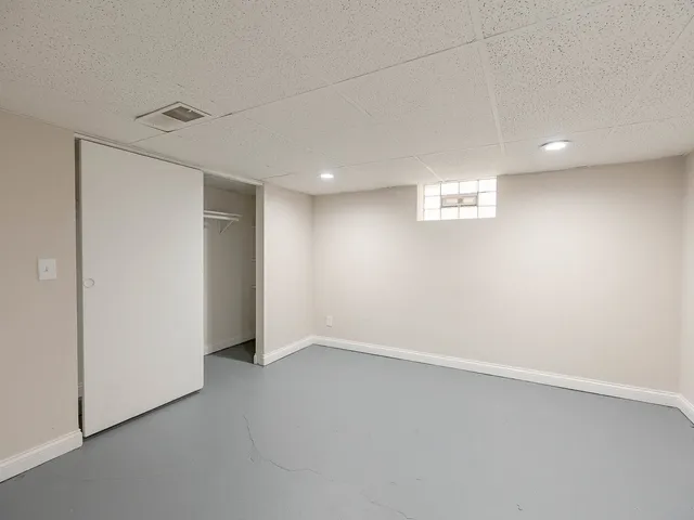 an empty room with a empty space and windows