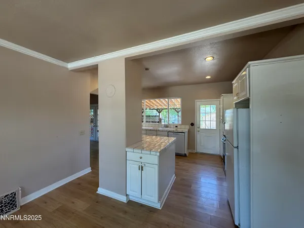 a kitchen with a refrigerator and a stove top oven