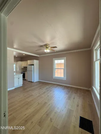 an empty room with windows and cabinet