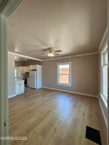 an empty room with windows and cabinet