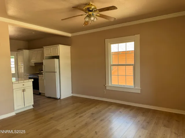 a kitchen with a refrigerator and a stove top oven