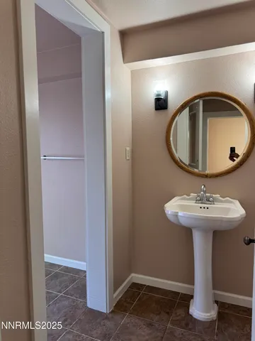 a bathroom with a sink toilet and mirror
