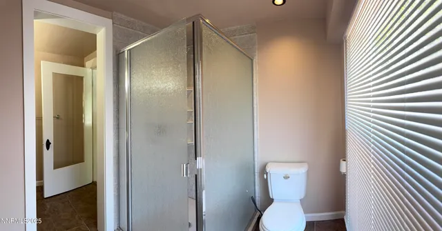 a bathroom with a toilet and a shower