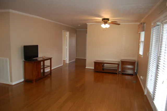 a view of room with window and wooden floor