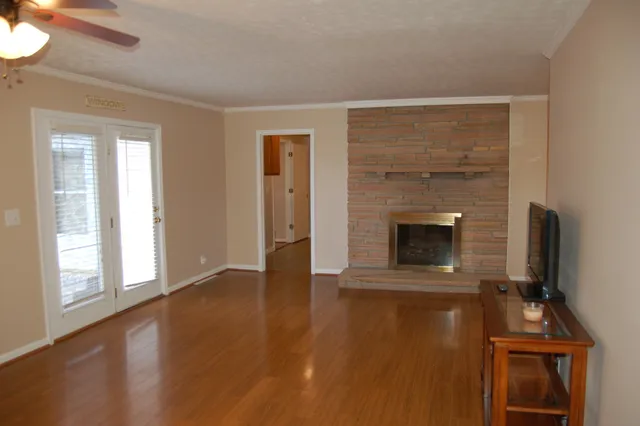 a view of a livingroom with a fireplace and a window