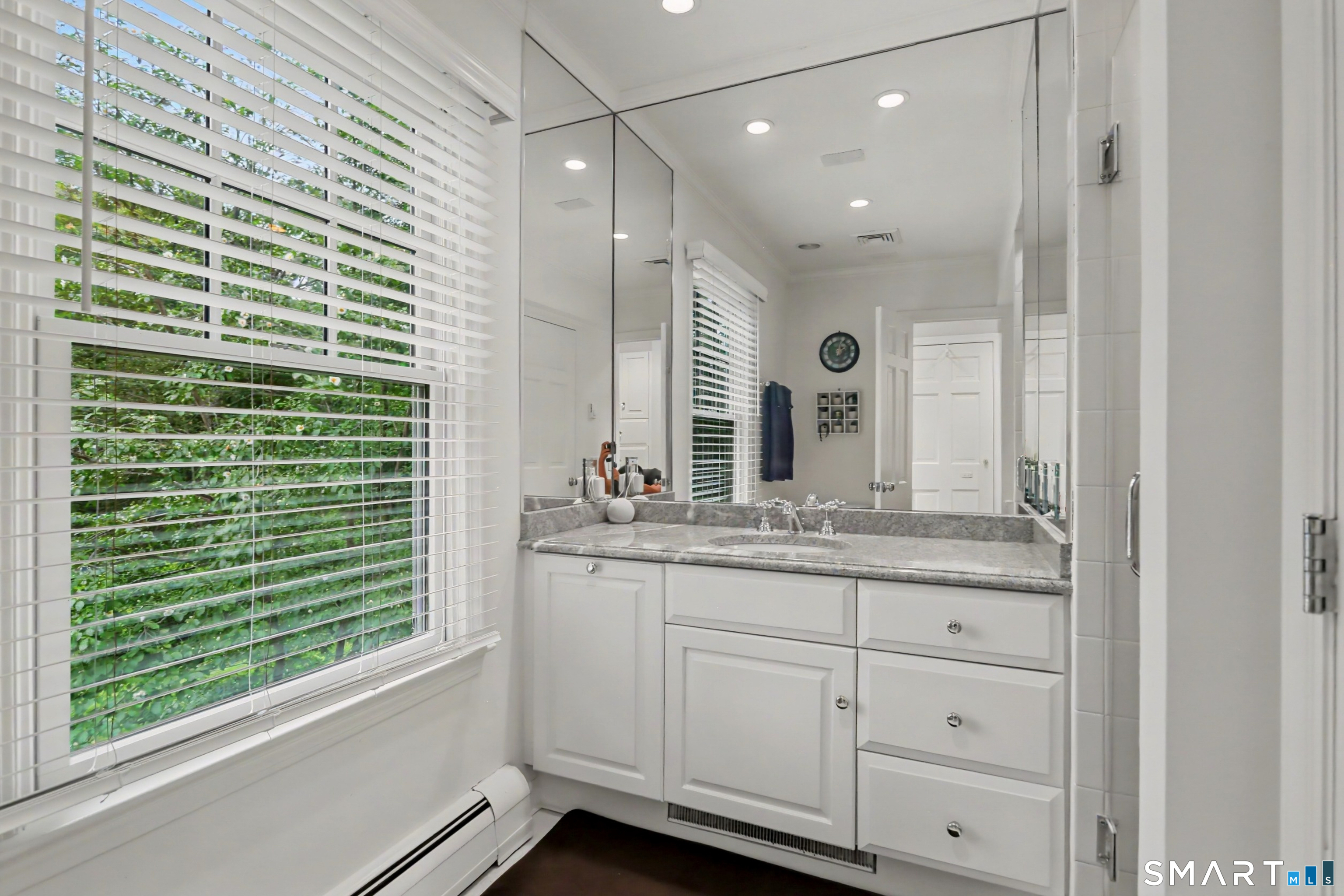 108 Logan Road New Canaan, CT 06840 - Photo 24 of 40 a bathroom with a granite countertop sink and a large mirror