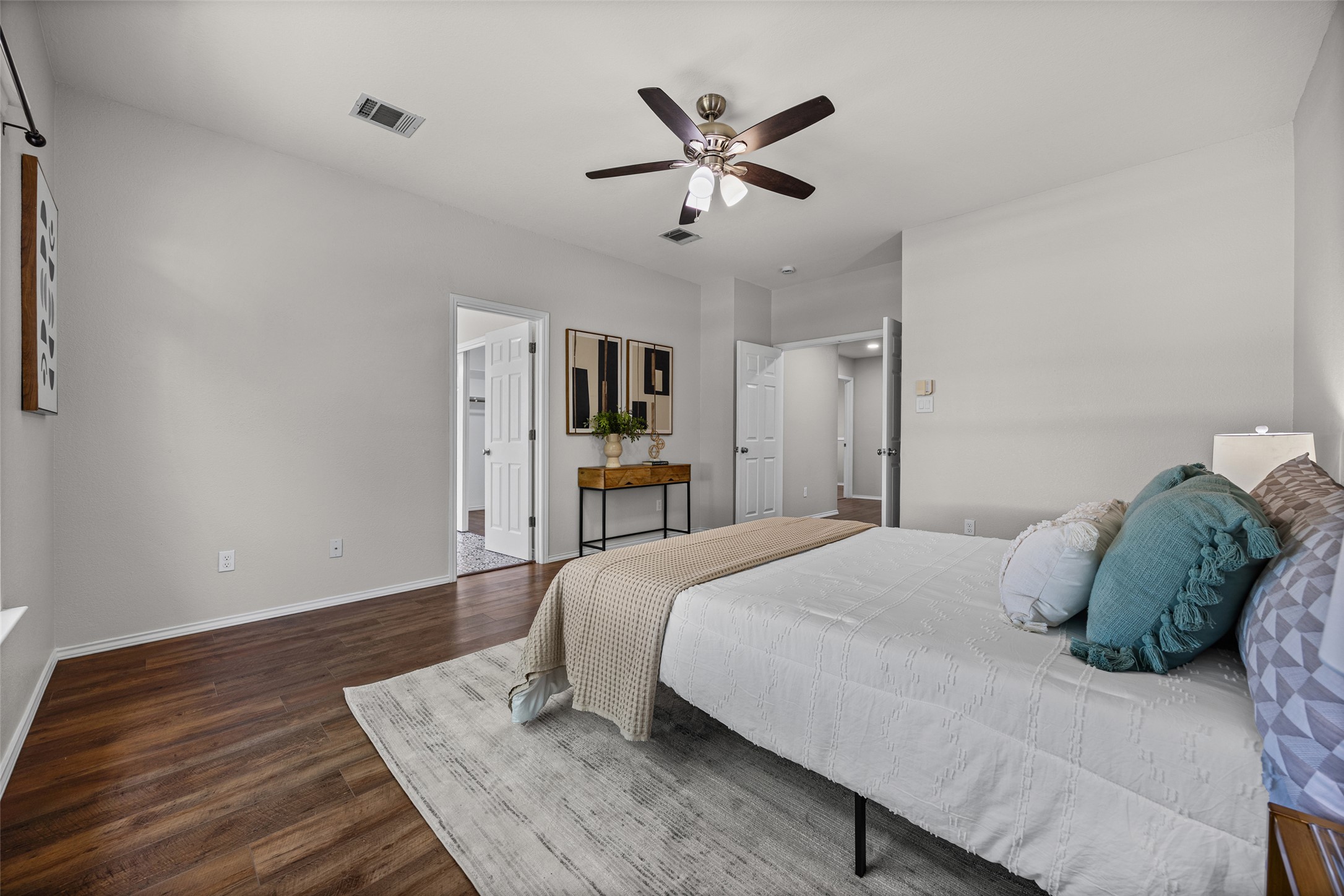1524 Lochaline Loop Pflugerville, TX 78660 - Photo 13 of 22 Rich hardwood floors complement a neutral palette in this spacious, well-lit bedroom.