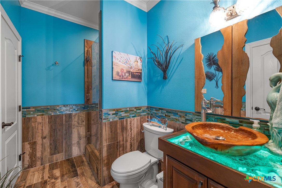 254 Sendera Loop Victoria, TX 77904 - Photo 40 of 48 a bathroom with a sink a toilet a mirror and shower curtain