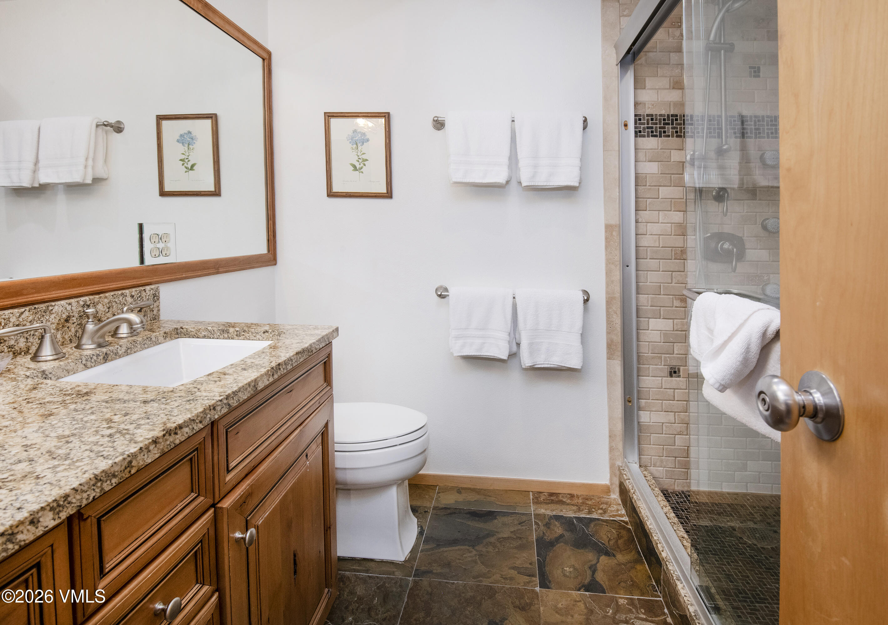 1100 North Frontage Road West, Unit 1519 Vail, CO 81657 - Photo 11 of 38 a bathroom with a granite countertop sink a toilet and a shower