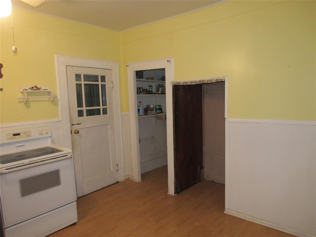 101 East Murray Street Denison, TX 75021 - Photo 14 of 32 a view of a kitchen with refrigerator and stove