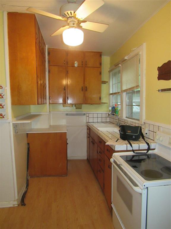 101 East Murray Street Denison, TX 75021 - Photo 16 of 32 a kitchen with a sink stove and cabinets