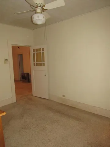 a view of a livingroom with a chandelier furniture and a ceiling fan