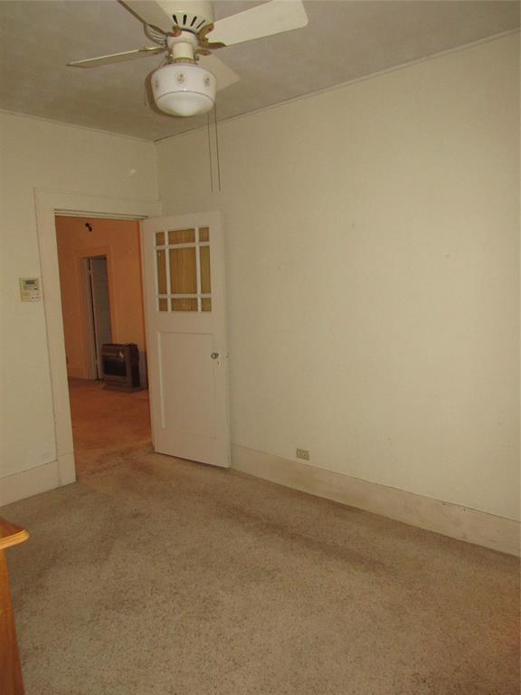 101 East Murray Street Denison, TX 75021 - Photo 18 of 32 an empty room with a chandelier fan and closet