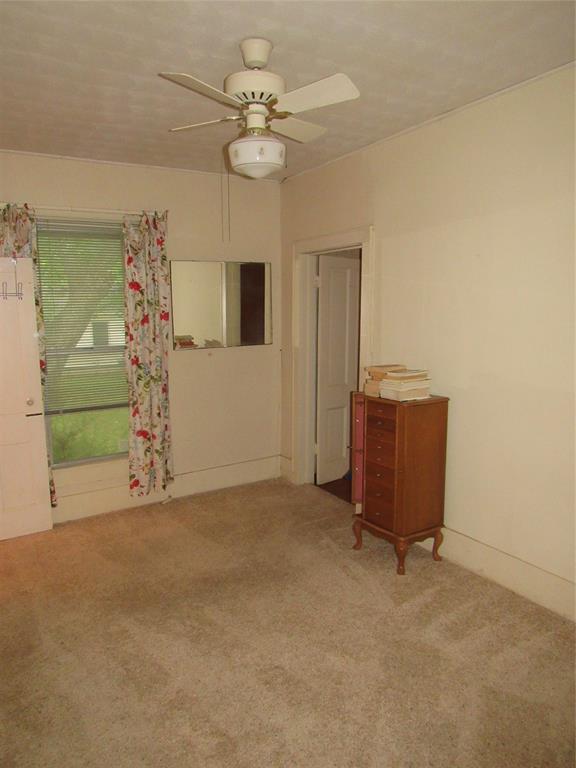 101 East Murray Street Denison, TX 75021 - Photo 19 of 32 a view of a livingroom with a chandelier furniture and a ceiling fan