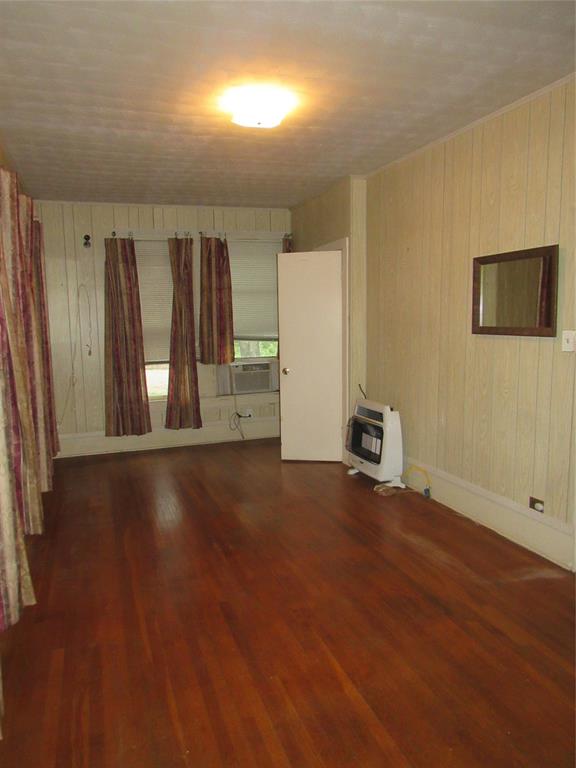 101 East Murray Street Denison, TX 75021 - Photo 21 of 32 an empty room with wooden floor and windows