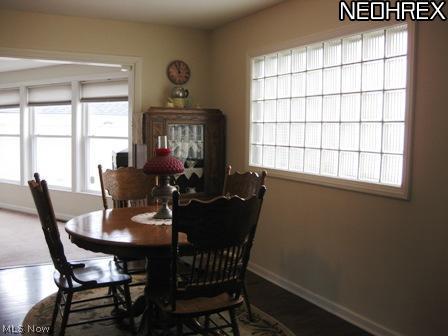 4238 Colony Road South Euclid, OH 44121 - Photo 4 of 24 Formal Dining Room with artistic designed glass window for light and privacy. This room flows into the Family Room that is light and bright with full wall windows and have Cellular Blinds throughout.