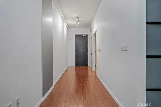 a view of a hallway with wooden floor