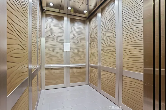 a living room with furniture and large windows