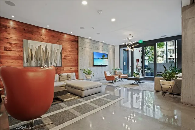 a living room with furniture and a chandelier