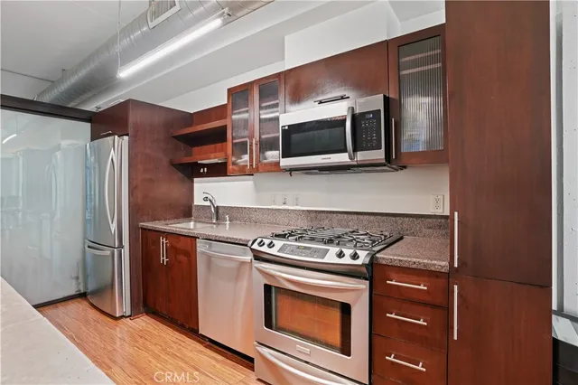 a kitchen with stainless steel appliances granite countertop a stove and a refrigerator