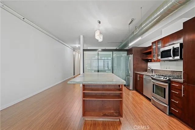 a kitchen with kitchen island a stove and a wooden floors