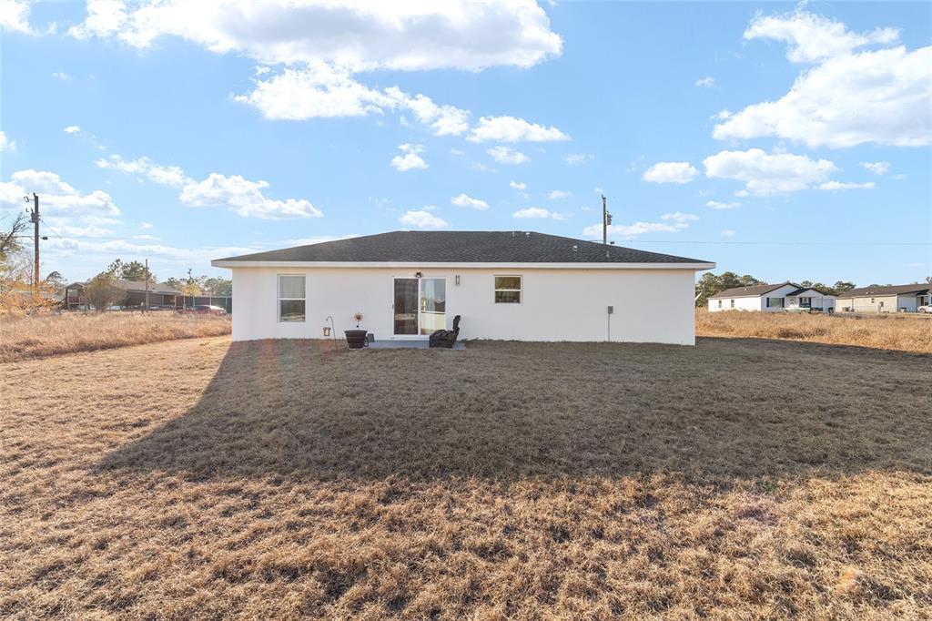 3597 Southwest 151st Avenue Ocala, FL 34481 - Photo 33 of 35 a view of a house with a yard