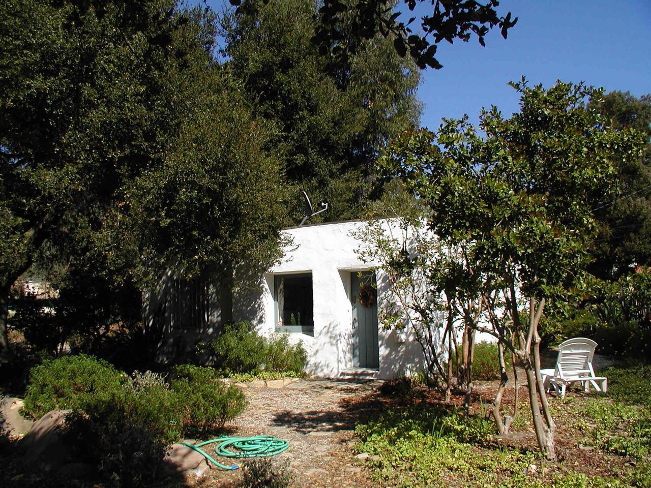 2121 Mission Ridge Road Santa Barbara, CA 93103 - Photo 3 of 5 a view of a white house with a tree and plants