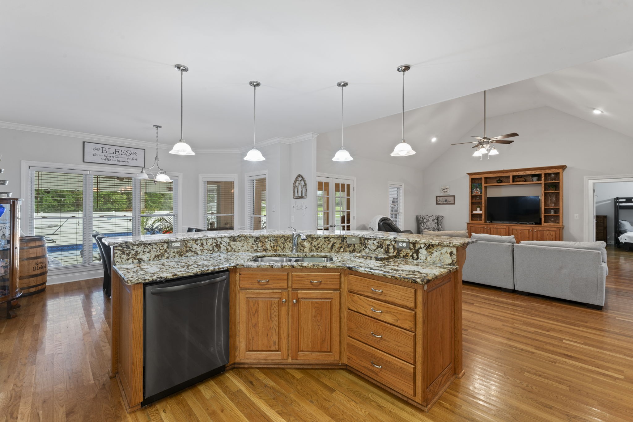 11237 Newtown Road Unionville, TN 37180 - Photo 18 of 46 a kitchen with kitchen island granite countertop a stove a counter top space a sink and a fireplace