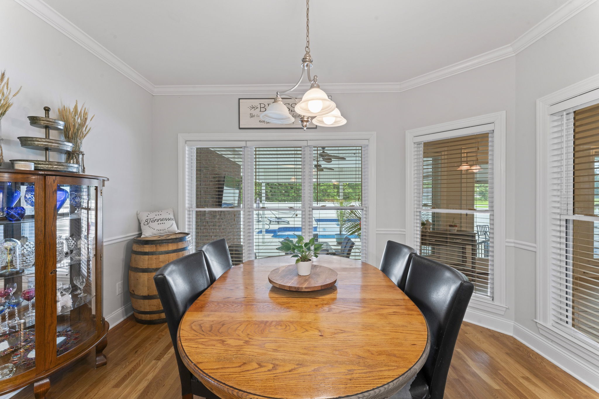 11237 Newtown Road Unionville, TN 37180 - Photo 21 of 46 a dining room with furniture a chandelier and wooden floor