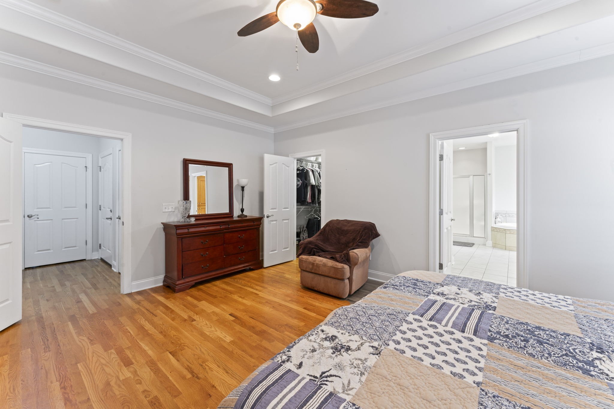 11237 Newtown Road Unionville, TN 37180 - Photo 25 of 46 a bedroom with a bed and a chandelier