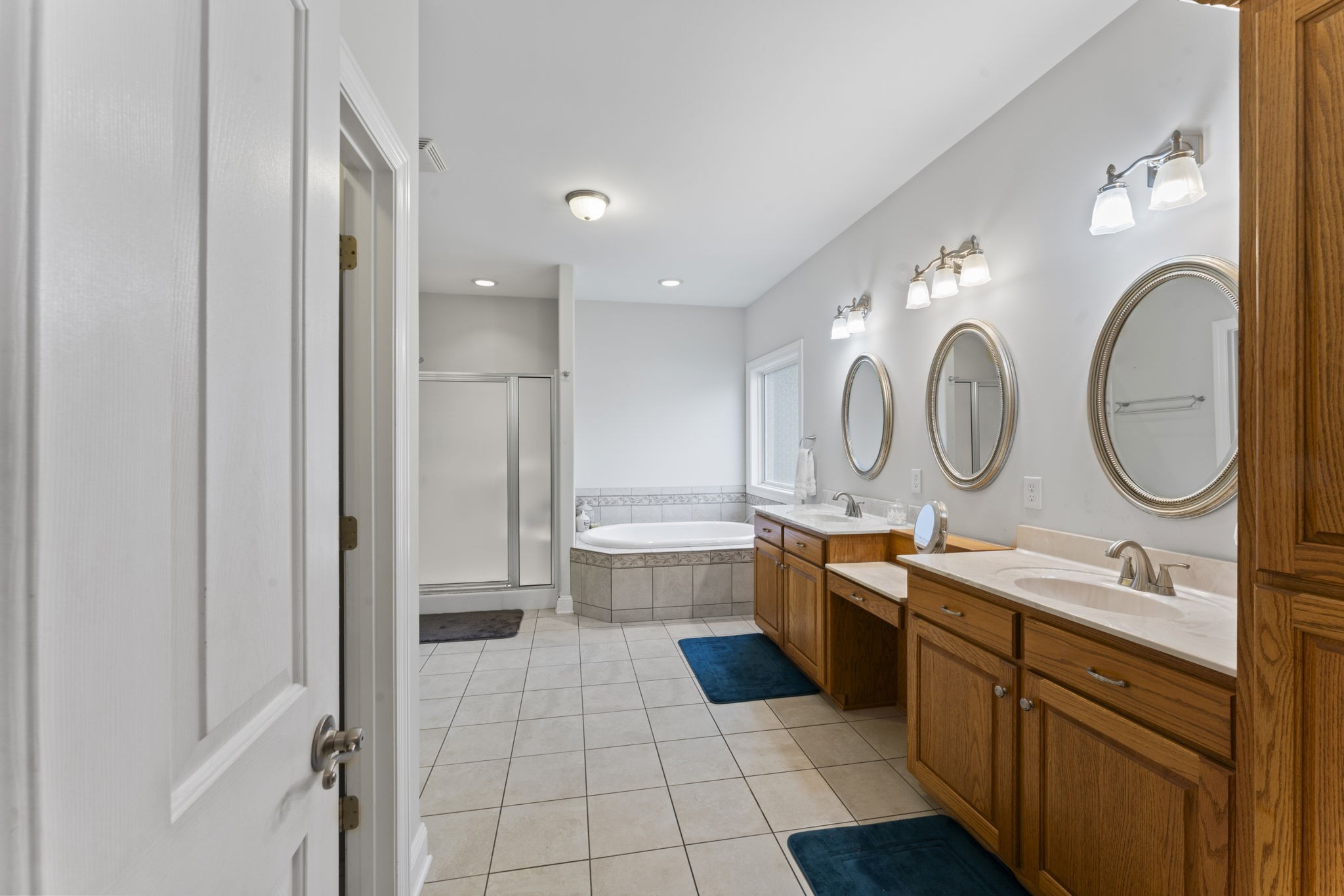 11237 Newtown Road Unionville, TN 37180 - Photo 26 of 46 a large bathroom with a double vanity sink a mirror and a bathtub