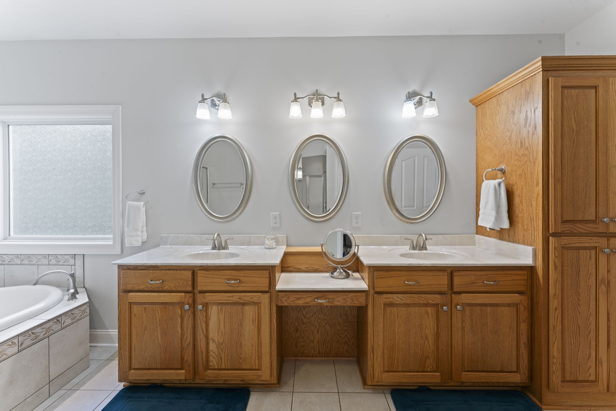 11237 Newtown Road Unionville, TN 37180 - Photo 27 of 46 a bathroom with a double vanity sink and a mirror