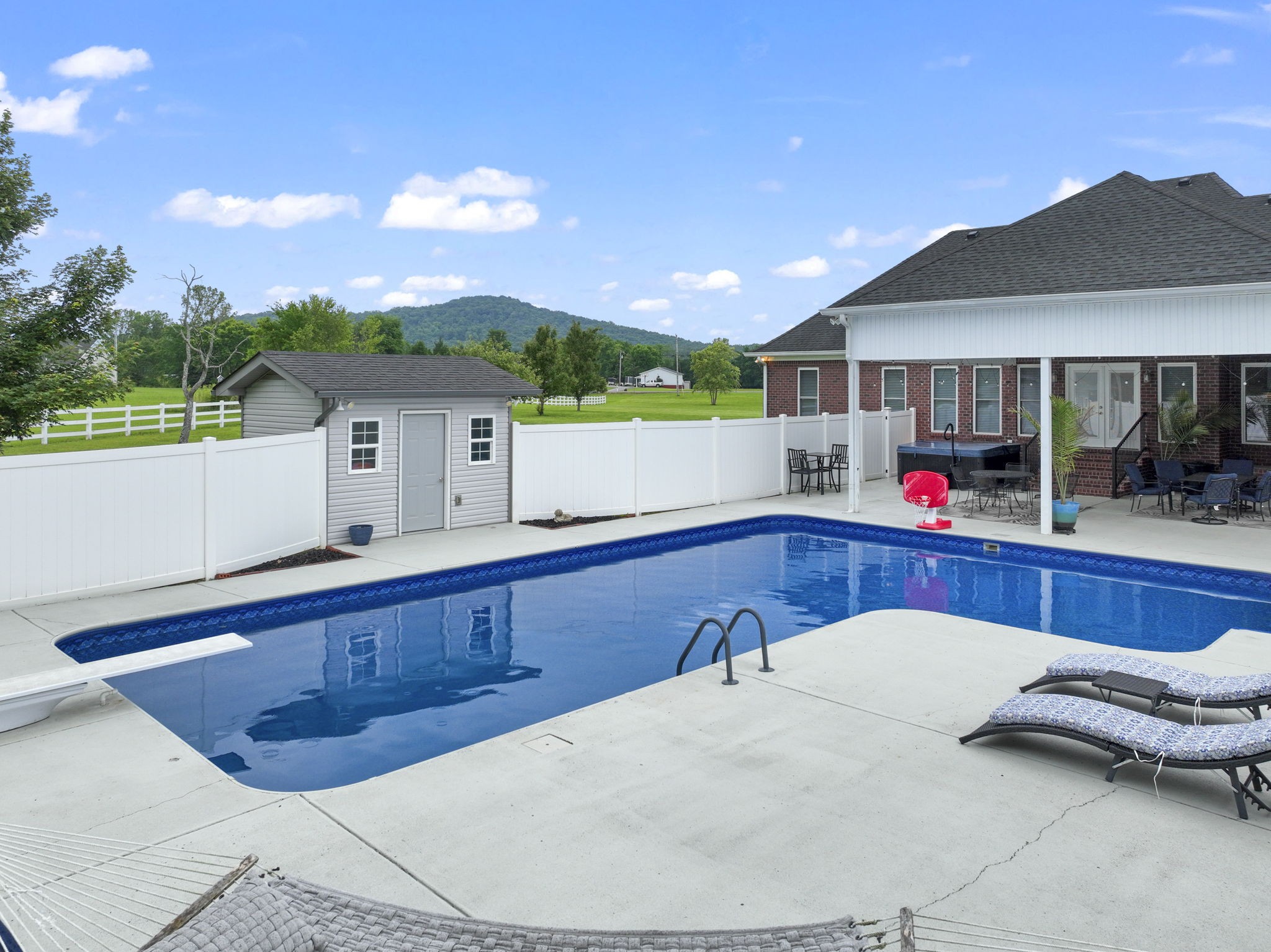 11237 Newtown Road Unionville, TN 37180 - Photo 36 of 46 a view of a house with swimming pool and a porch