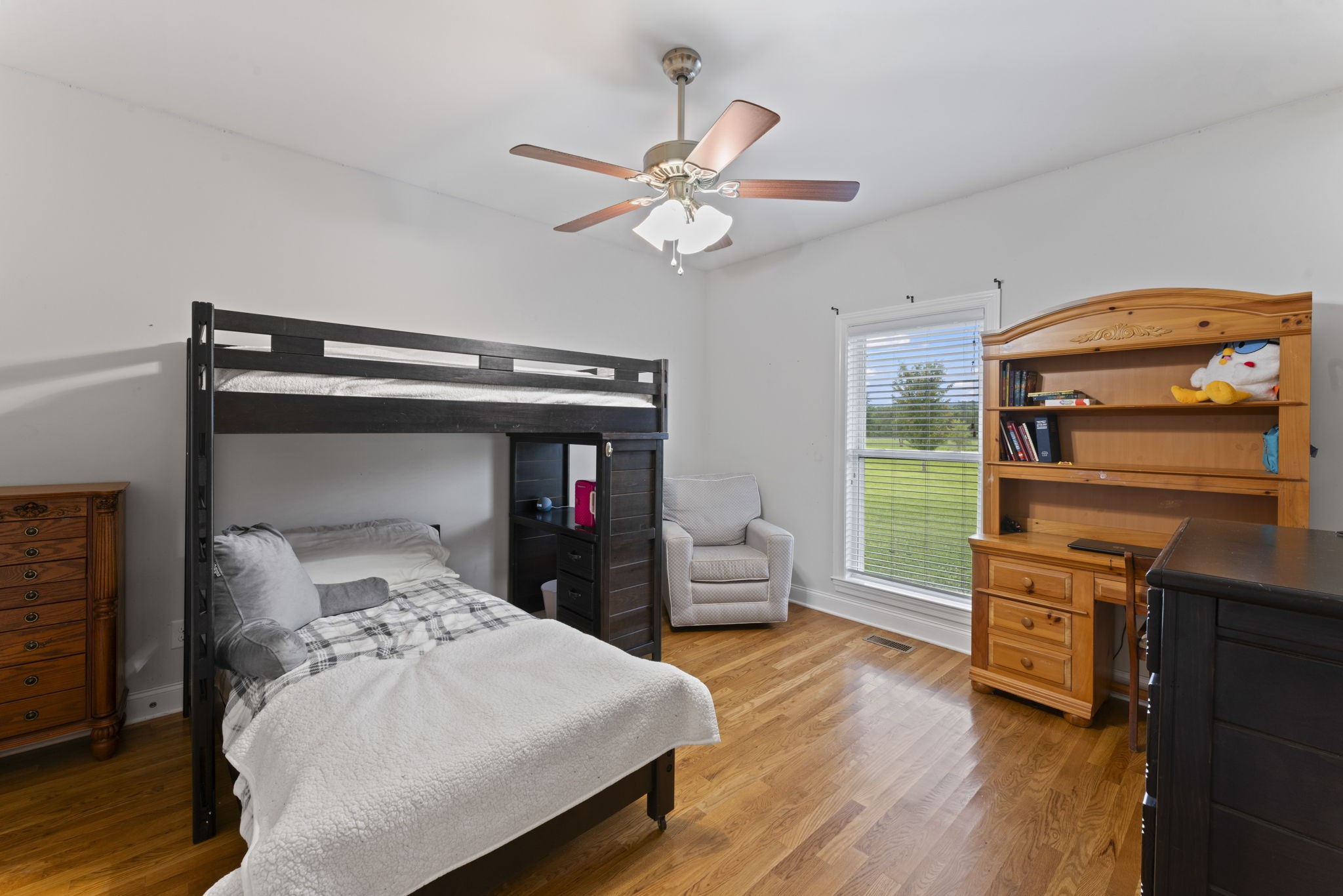 11237 Newtown Road Unionville, TN 37180 - Photo 10 of 46 a bedroom with a bed and a chandelier