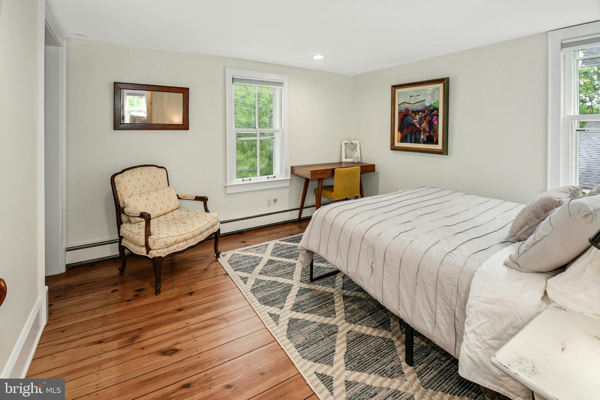 155 Old Philadelphia Road Riegelsville, PA 18077 - Photo 19 of 42 a bedroom with a bed and a chair with wooden floor