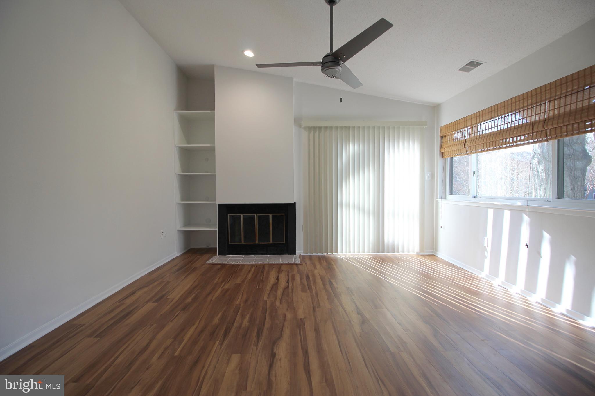 1956A Villaridge Drive, Unit 1956B Reston, VA 20191 - Photo 9 of 24 a view of an empty room with wooden floor and a window