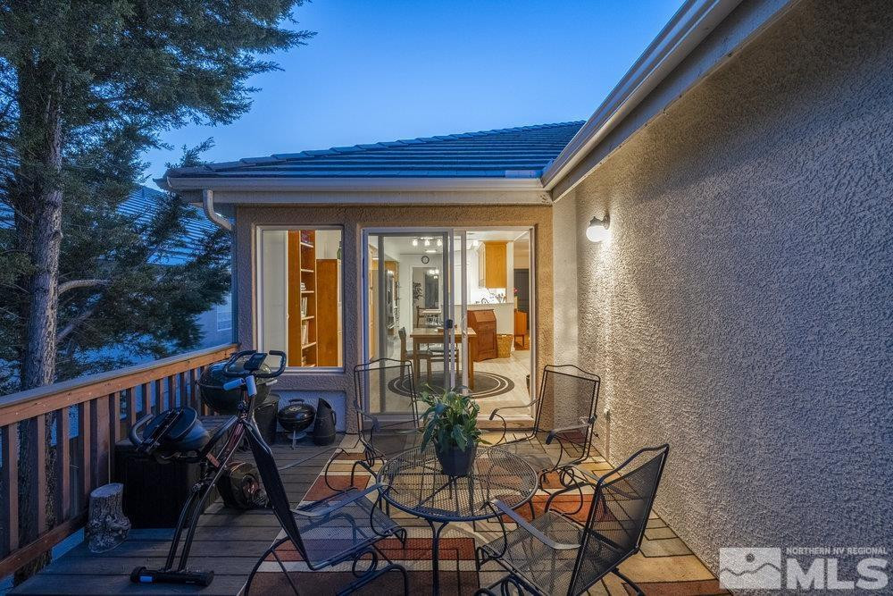 6238 Golden Meadow Road Reno, NV 89519 - Photo 12 of 40 a view of a balcony with chairs and floor to ceiling window and wooden fence