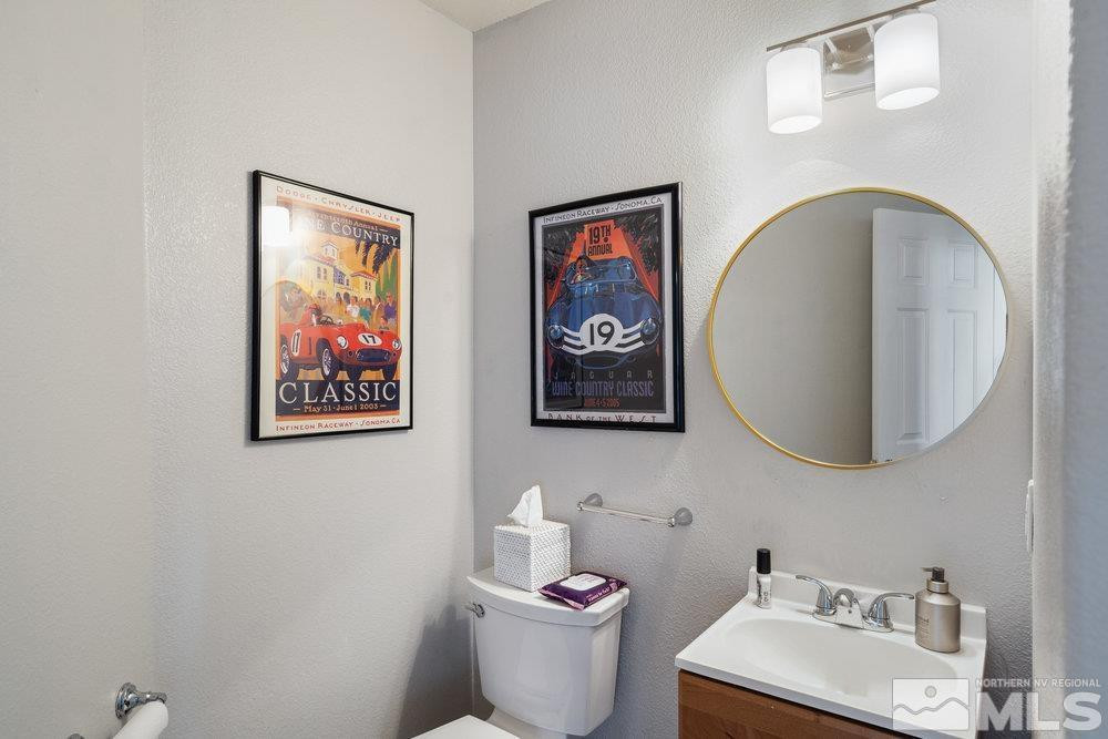 6238 Golden Meadow Road Reno, NV 89519 - Photo 26 of 40 a bathroom with a toilet a sink and a mirror