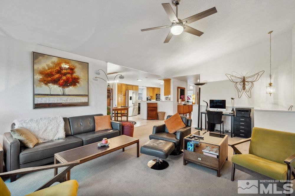 6238 Golden Meadow Road Reno, NV 89519 - Photo 31 of 40 a living room with furniture a couch and a ceiling fan
