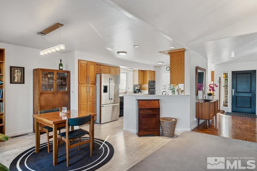 6238 Golden Meadow Road Reno, NV 89519 - Photo 5 of 40 a living room with furniture a dining table and kitchen view
