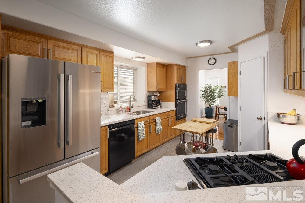 6238 Golden Meadow Road Reno, NV 89519 - Photo 6 of 40 a kitchen with a refrigerator and a stove