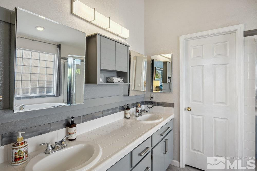 6238 Golden Meadow Road Reno, NV 89519 - Photo 10 of 40 a bathroom with 2 sink and a mirror