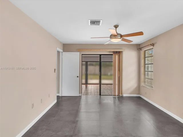a view of a hallway with wooden floor and closet