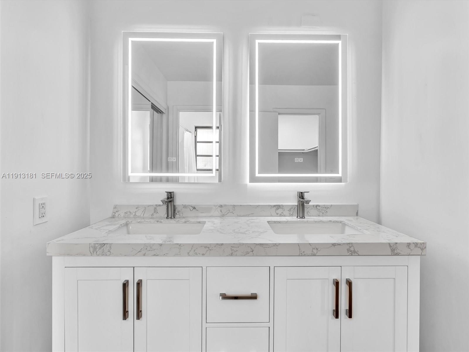 6360 Simmons Street Miami Lakes, FL 33014 - Photo 19 of 39 Newly updated with double sink vanity, anti-fog LED mirror, new shower/bath fixtures