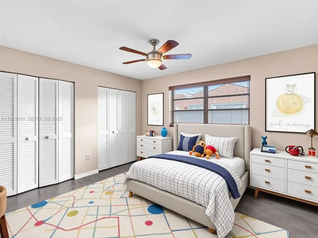 an empty room with a ceiling fan and a window