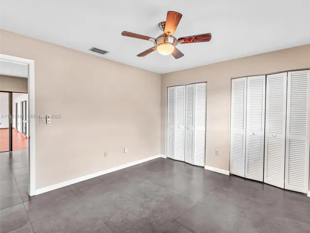 a bedroom with bed and a chandelier