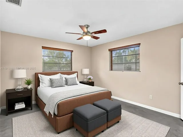 a view of a room with a ceiling fan and a window
