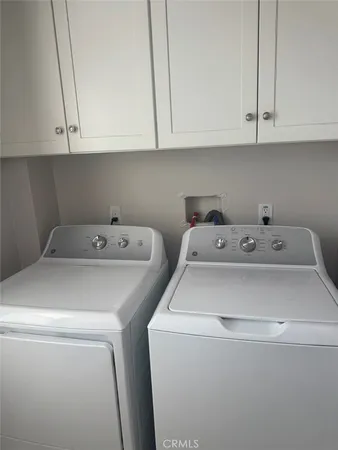 a kitchen with stainless steel appliances granite countertop a stove top oven a sink dishwasher and a refrigerator